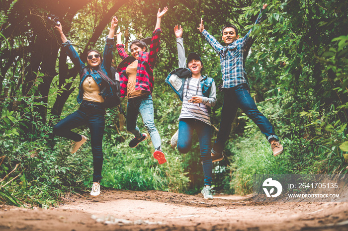 Group of happy Asian teenage adventure traveler trekkers group jumping together in mountain at outdo