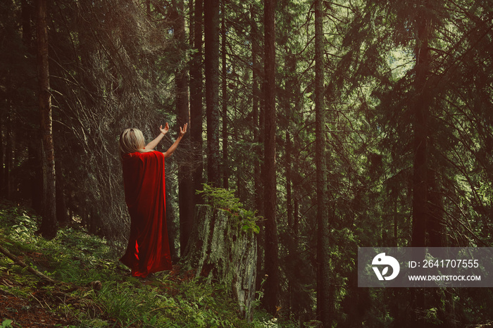 Woman praying in the woods