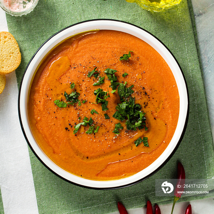 cream soup of red lentils with tomatoes on the table. healthy vegan warming food for the whole famil