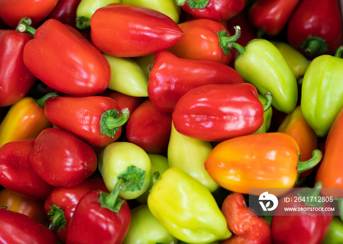 Yellow, orange, red, green sweet peppers on the counter of a vegetable shop. High quality photo