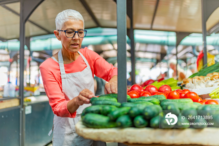 Senior Woman Selling Fresh Local Vegetable From Farm at Market. Senior woman owner fresh grocery org