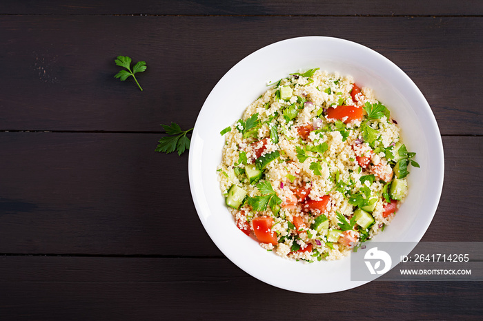 Traditional Lebanese Salad Tabbouleh. Couscous with parsley, tomato, cucumber, lemon and olive oil. 