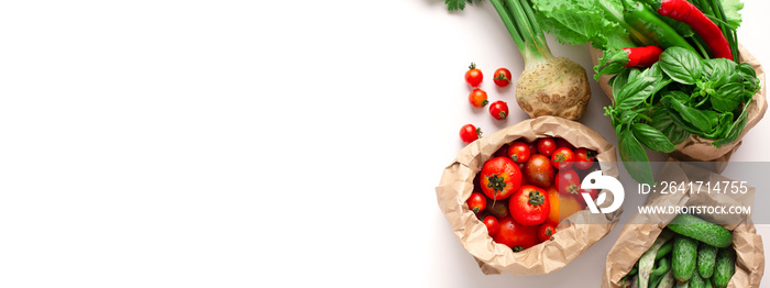 Garden fresh vegetables in eco friendly bags on white