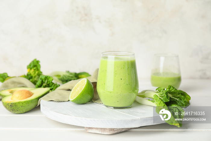 Glass of healthy smoothie and ingredients on table