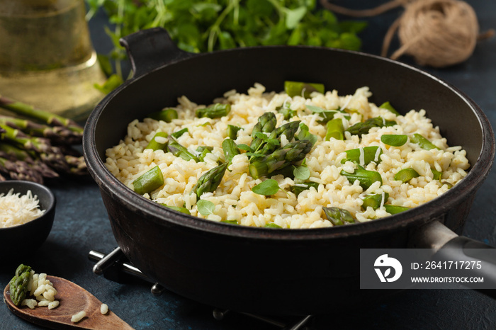 Classic Italian risotto with asparagus. Front view. Darkblue background.