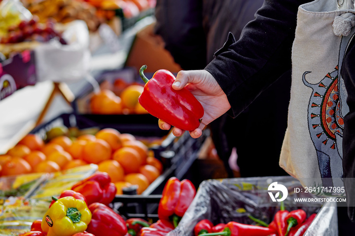 Buying bell peppers at the vegetable market. Copy space