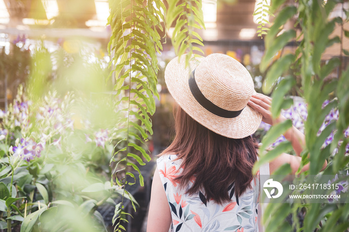 Young woman walking in the orchid garden