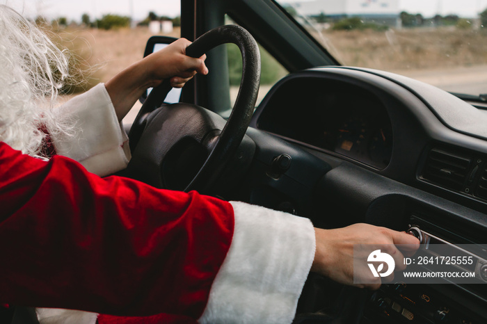 Santa Claus listing music in a van