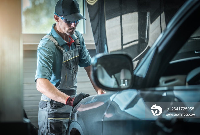 Car Mechanic Fixing Vehicle