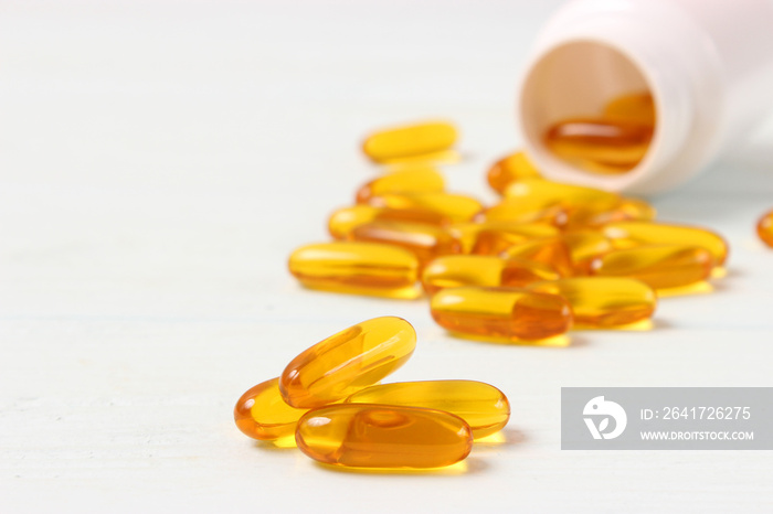 Omega-3 capsules on a colored background. Fish oil, healthy supplements