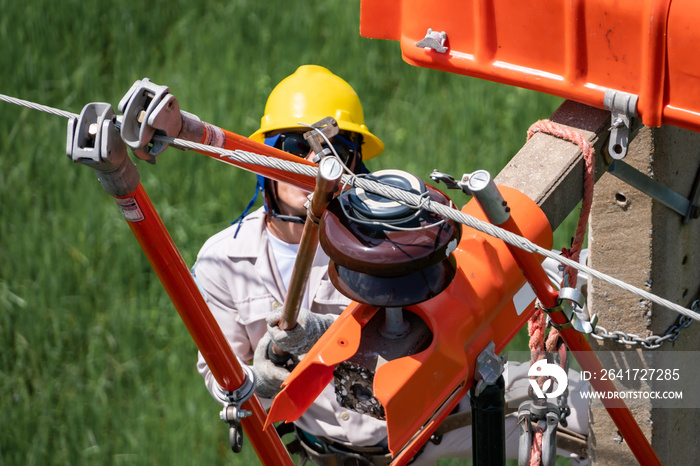 The lineman used tie stick to carve the tie wire used to wrap the electrical wires attached to the d