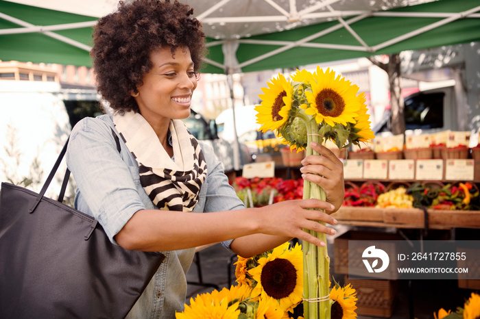 Mature woman buying sunflowers