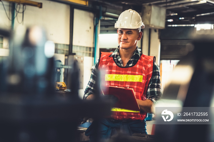 Manufacturing worker working with clipboard to do job procedure checklist . Factory production line 