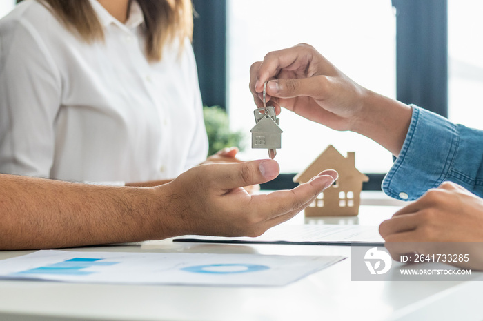 Close up hand of home,apartment agent or realtor was holding the key to the new landlord,tenant or r