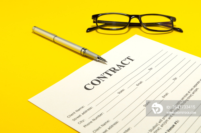 The contract for the yellow table and pen.