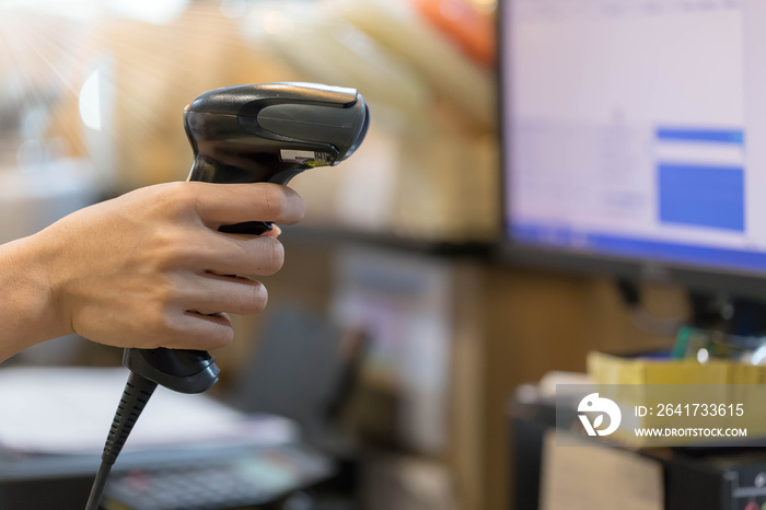 Close up barcode scanner in hand on blurred background,Inspection of goods in the warehouse,The conc