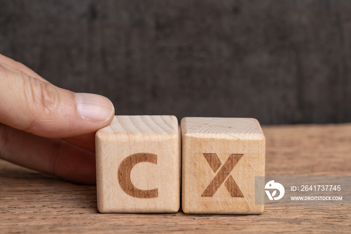 CX, Customer Experience concept, hand holding cube wooden block arrange the word with alphabet CX wi