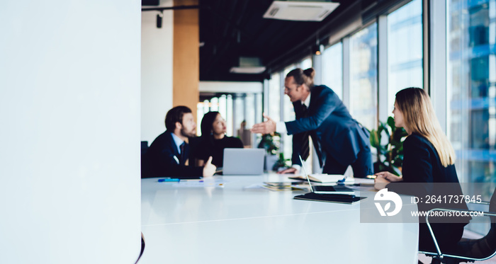 Blurred image of male and female crew of finance experts having meeting table for discussing project