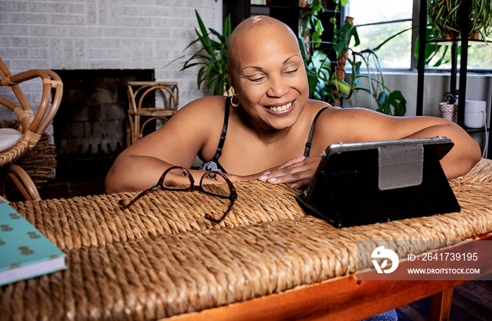 Bald Black woman using tablet