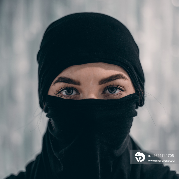 Woman portrait with deep eyes and eyelashes beauty make up, wearing black scarf niqab hijab around f