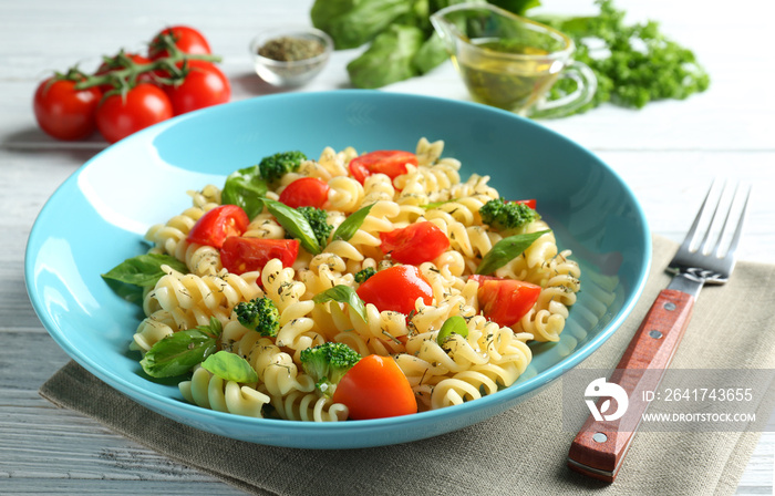 Plate of pasta salad with tomatoes and broccoli