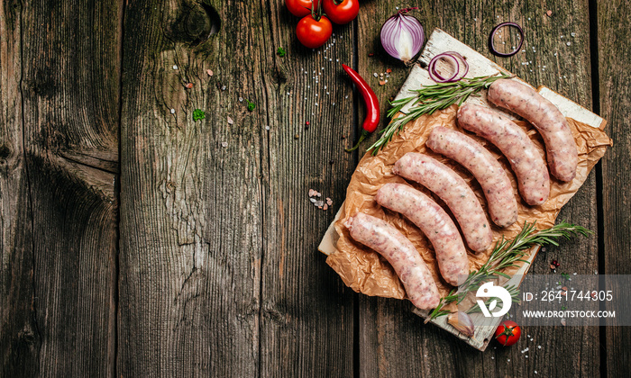 raw sausages with spices and rosemary on cutting board. Cooking ingredients. Natural healthy food co