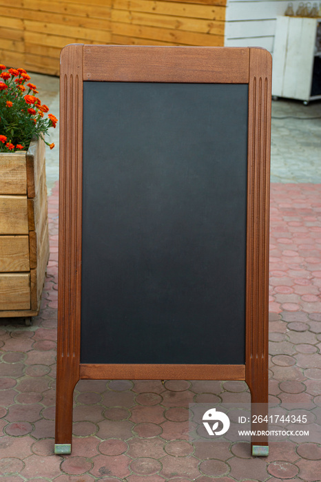 Empty restaurant menu blackboard on the street, menu chalkboard mockup, menu board template