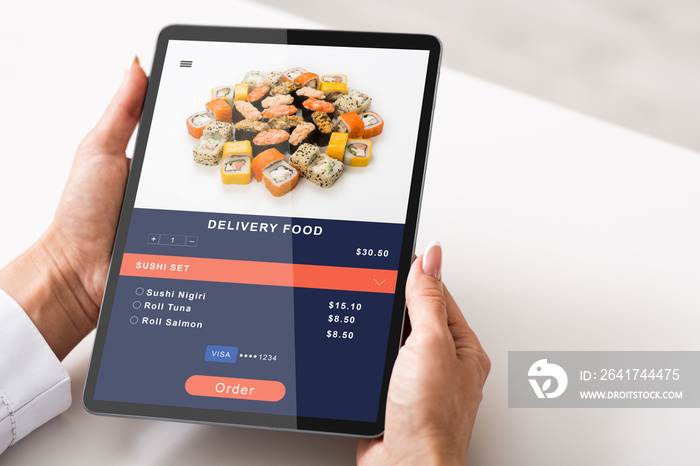 Modern food ordering and convenient application for tasty meal in menu. Woman holding tablet and ord