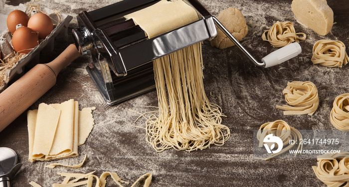 Preparing homemade fettuccine on pasta machine