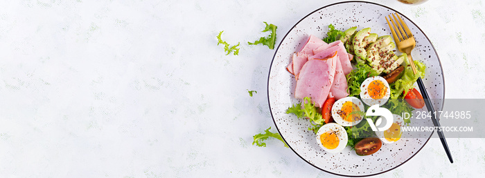 Ketogenic/paleo diet. Boiled eggs, ham, avocado and fresh salad.  Keto breakfast. Brunch.  Top view,