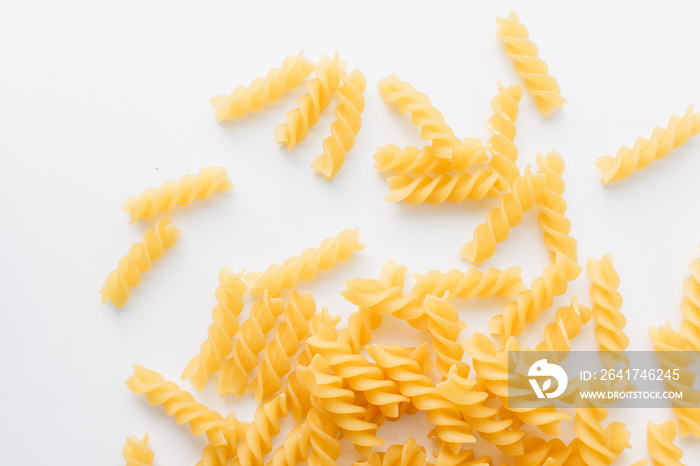 Pile of uncooked macaroni on white background