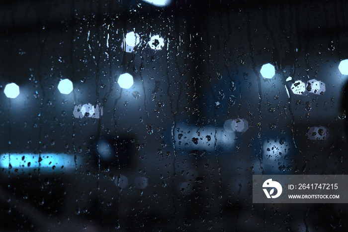 Rain drops on window with street bokeh lights