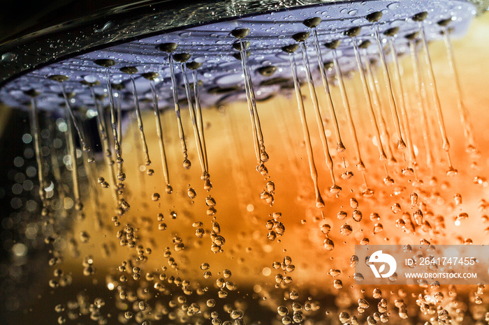 Shower head and falling water drops.