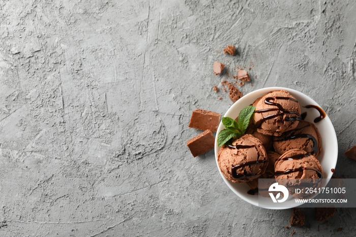 Bowl with ice cream on grey background, top view