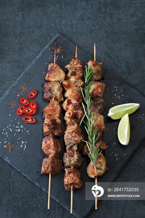 Delicious kebabs with spices. Kebab on wooden sticks.