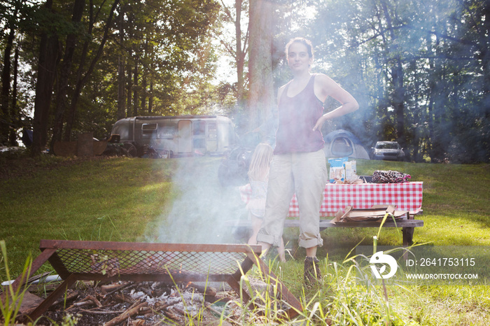 Portrait of woman camping with girl