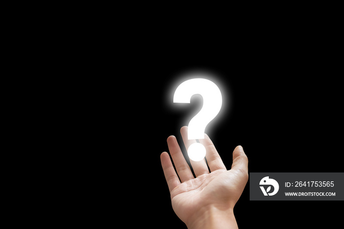 Hand holding white question mark icon symbol in black background.