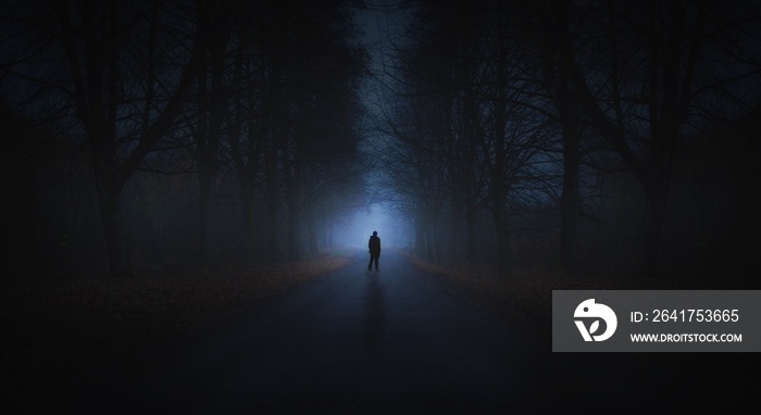 Surreal horror scene with alone strange man in dark night forest
