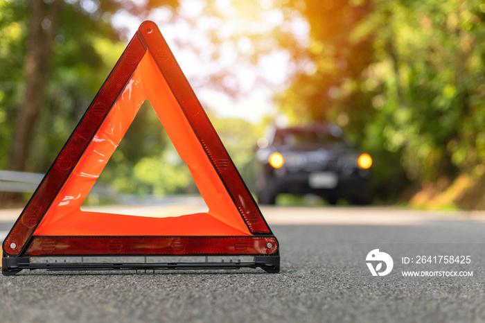 Red triangle, red emergency stop sign, red emergency symbol and black car stop and park on road.