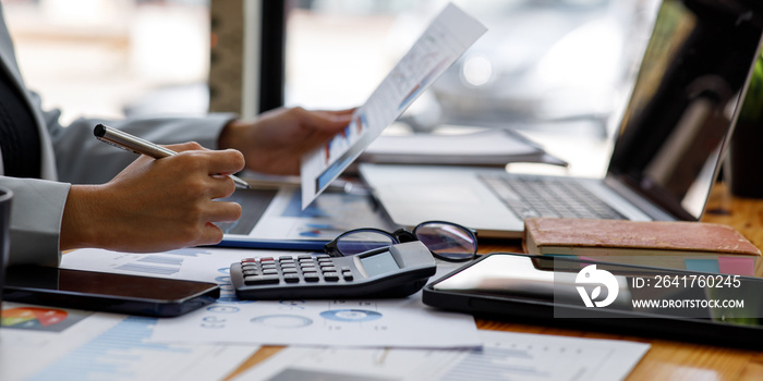 Close up businesswoman hand using calculator and writing make a note with calculate about finance ac