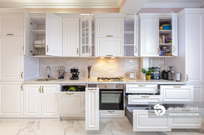 Luxury modern white kitchen interior with open doors and drawers