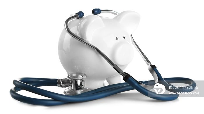 Piggy bank with stethoscope isolated on white