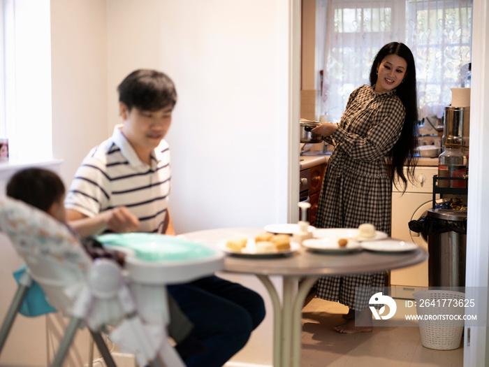 Parents with baby son spending time at home