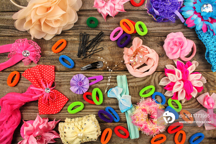 Different hair clips on wooden background. Top view.