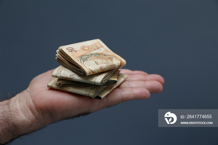 Hands holding Brazilian real notes - Money from Brazil - Notes of Real - Brazil BRL banknote