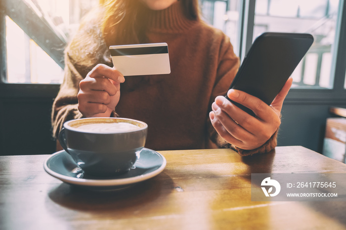 A woman using credit card for purchasing and shopping online on mobile phone