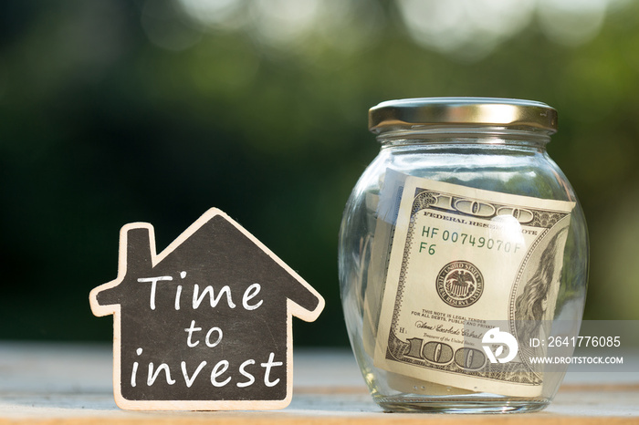 Time to Invest written on the little house shape tag - real estate concept