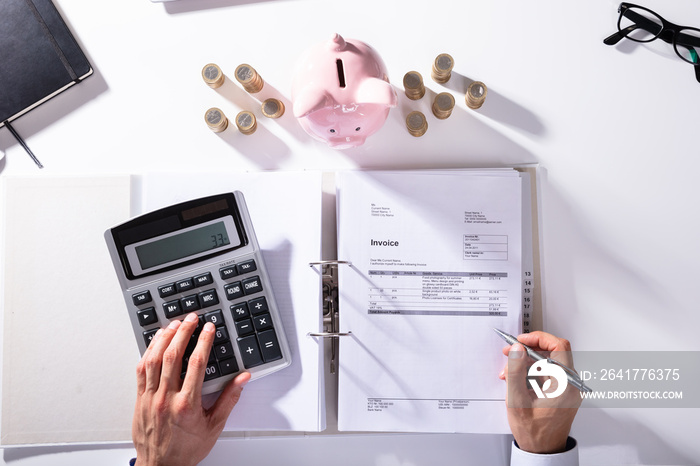 Elevated View Of Businessman Calculating Invoice