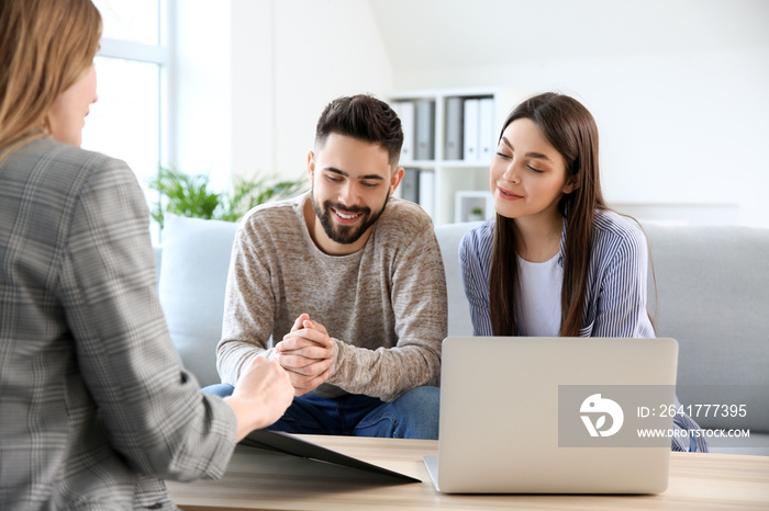 Young couple in office of real estate agent