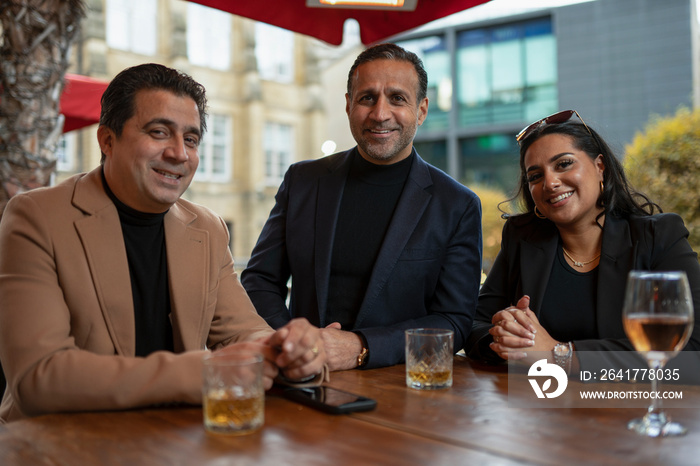 Portrait of business people having meeting in bar